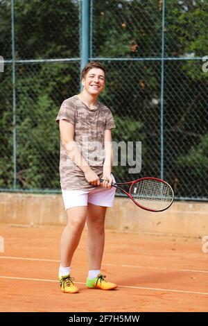 Young boy stay on tennis court Stock Photo