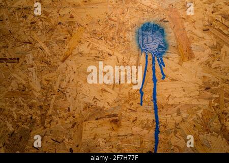 Dirty OSB wood board. OSB panel board with a splat of red paint on it. Concept to write sometnhing on plate Stock Photo