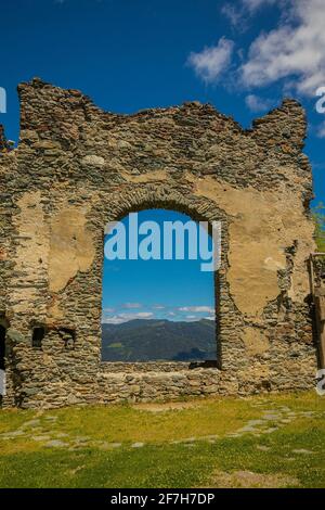 Inside of Steinschloss castle ruins rising above the mura valley in styria, Austria. Medieval ruins in Austria on a sunny day, look through one of the Stock Photo