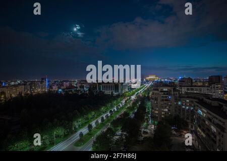 Seat of Romanian parliament, huge building in the centre of Bucharest, Romania on summer night. Evening view over the avenue looking towards parliamen Stock Photo