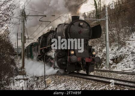 Front of the european style war train steam locomotive. German war locomotive built during the second world war rushing on the snowy train track, lett Stock Photo