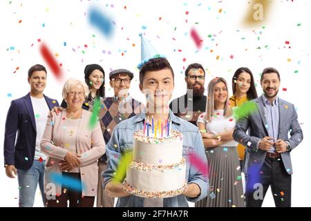 Birthday party with a male teenager holding a cake with his family around isolated on white background Stock Photo