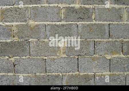 Fragment of a wall of gray rectangular concrete blocks Stock Photo