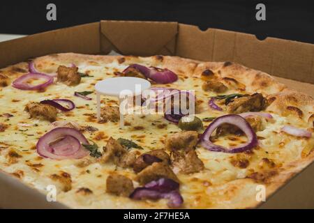 Pizza saver or ottoman, known also as pizza table, used in pizza deliveries to save the pizza being squished in a cardboard box. Tasty delicious pizza Stock Photo