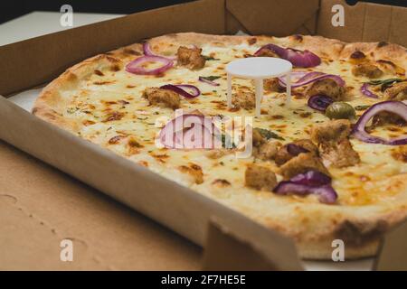 Pizza saver or ottoman, known also as pizza table, used in pizza deliveries to save the pizza being squished in a cardboard box. Tasty delicious pizza Stock Photo