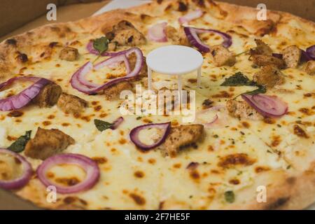 Pizza saver or ottoman, known also as pizza table, used in pizza deliveries to save the pizza being squished in a cardboard box. Tasty delicious pizza Stock Photo