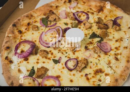 Pizza saver or ottoman, known also as pizza table, used in pizza deliveries to save the pizza being squished in a cardboard box. Tasty delicious pizza Stock Photo