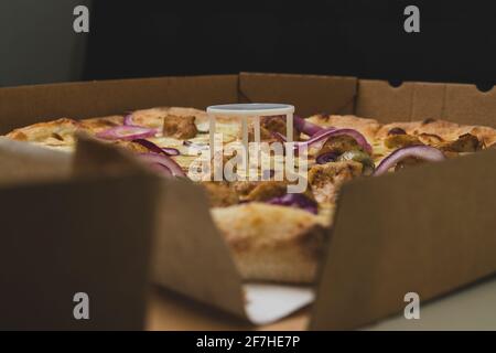 Pizza saver or ottoman, known also as pizza table, used in pizza deliveries to save the pizza being squished in a cardboard box. Tasty delicious pizza Stock Photo