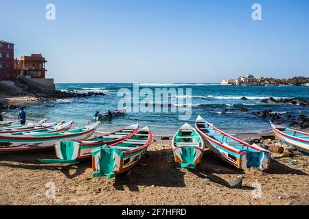 Fishing boats in Ngor Dakar, Senegal, called pirogue or piragua or piraga. Colorful boats used by fishermen standing in the bay of Ngor on a sunny day Stock Photo