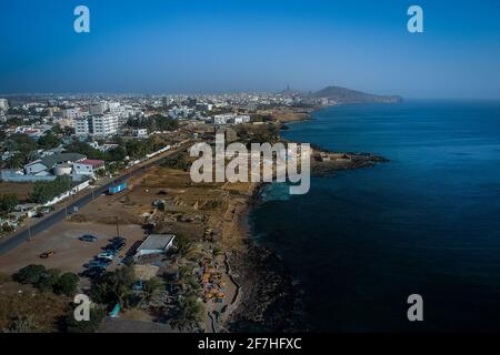 Aerial view of Dakar, looking from Ngor towards the African Renaissance Monument which is seen in the far background. Beach and a bar is seen in the f Stock Photo