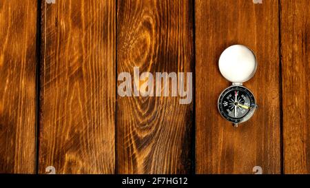 compass on the brown wooden table background. Stock Photo