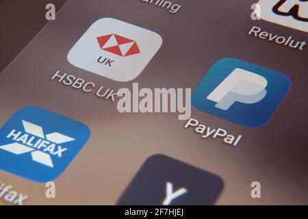 ARM company logo seen on the smartphone, gavel and NVIDIA logo on the blurred Apple M1 ARM-based laptop screen. Concept for company acquisition and an Stock Photo