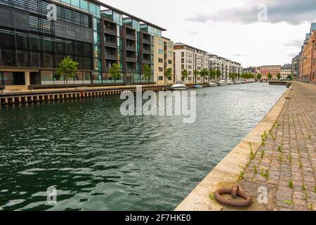 View of a modern residential district of Copenhagen, Denmark, with the canal, moored boats and buildings of contemporary architecture Stock Photo