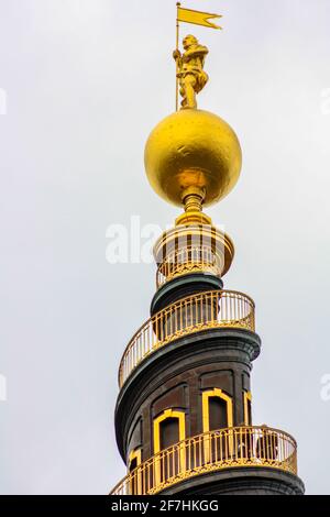 The top of the tower of the Vor Frelsers Kirke, with the characteristic spiral staircase and the golden statue at the top Stock Photo