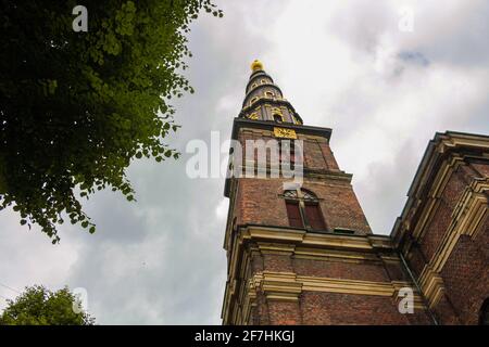 The tower of the Vor Frelsers Kirke, with the characteristic spiral staircase and the golden statue on top Stock Photo