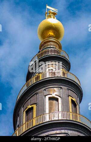 The top of the tower of the Vor Frelsers Kirke, with the characteristic spiral staircase and the golden statue at the top Stock Photo