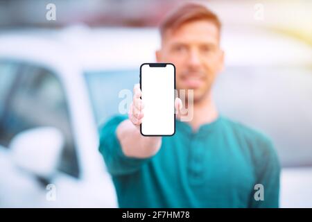 Smartphone mockup, blank screen. Man showing his modern phone with blank space Stock Photo