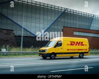 Side view of fast driving DHS fast delivery Volkswagen van on the Dutch highway Stock Photo