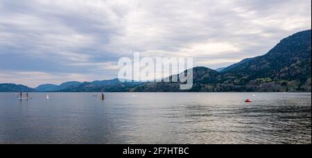 PENTICTON, CANADA - JULY 3, 2020: recreation time paddle boarding on scenic peaceful mountain lake. Stock Photo