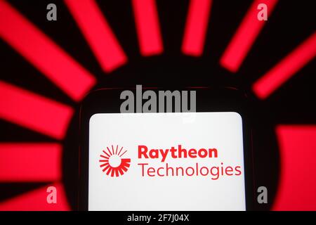 In this photo illustration the Raytheon Technologies logo of an US aerospace and defense company is seen on a smartphone and a pc screen. Stock Photo
