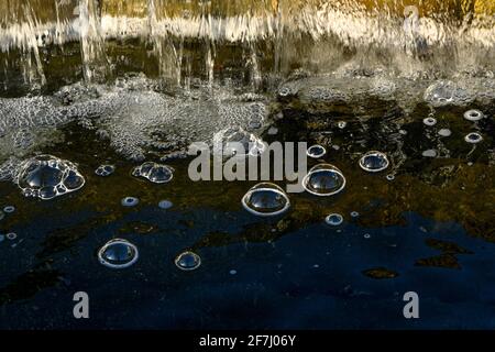 Bubble domes on water created by aeration from mini waterfall Stock Photo