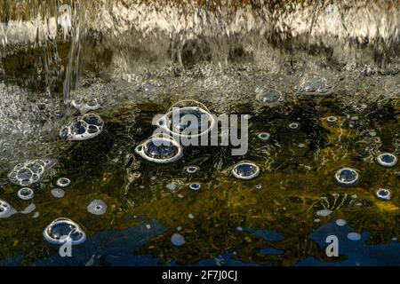 Bubble domes on water created by aeration from mini waterfall Stock Photo