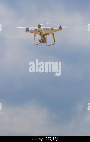 Drone in flight flying over the ocean Stock Photo