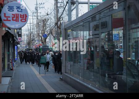 people near bus station, cold weather in winter Stock Photo