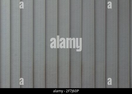 Full frame abstract art design texture background of vertical window blinds in a gradient shade of gray Stock Photo