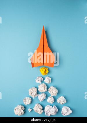 Launching paper rocket with jet stream of paper balls, creativity concept or new ideas metaphor, start up business , new year’s resolution Stock Photo