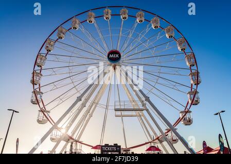 Adelaide, South Australia - January 12, 2019: Glenelg Mix102.3 Giant Ferris Wheel viewed from the Moseley Square on a bright summer day Stock Photo