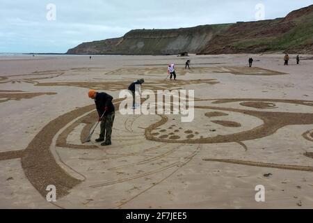 The 50-metre sand drawing being created by Sand In Your Eye for Surfers Against Sewage's new Million Mile Beach Clean campaign, on Cayton Bay in Yorkshire. Issue date: Thursday April 8, 2021. Stock Photo