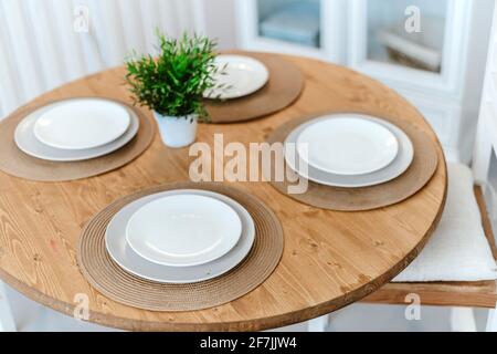 table set for dinner in a home kitchen. Stock Photo