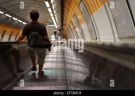 A man walking on vintage subway escalator, Capital city Prague, Czech Republic Stock Photo