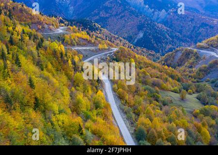 Winding road in the mountains, autumn forest view from a drone Stock Photo