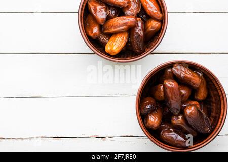 Dried date fruit in bowl.Traditional oriental sweets.Copy space Stock Photo