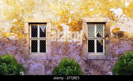 House wall country house old field stone sandstone lead glass window afterglow dawn worn weathered craggy rough abandoned Italy France rural used up Stock Photo