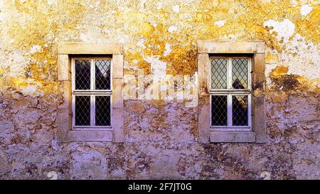 House wall country house old field stone sandstone lead glass window afterglow dawn worn weathered craggy rough abandoned Italy France rural used up Stock Photo