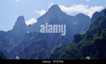 Green mounatins with river valley geomorgy under blue sky in Zhangjiajie national forest park. Stock Photo