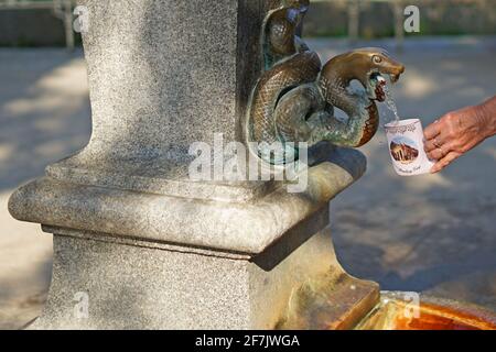 Karlovy Vary, Czech Republic - August 30 2019: Mineral spring drinking with Karlovy Vary spa cup Stock Photo