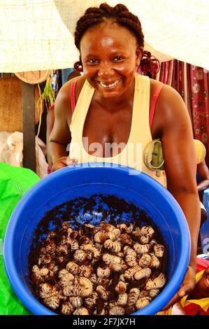 Congolese women, travelling on a barge from Kisangani to Kinshasa in the Democratic Republic of Congo, selling Palm Grubs to fellow passengers. Stock Photo