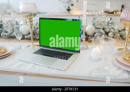 laptop with green screen - chromakey near New Year's decorations. christmas theme. Stock Photo