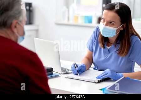 Female doctor conducts a medical interview with the senior patient ...