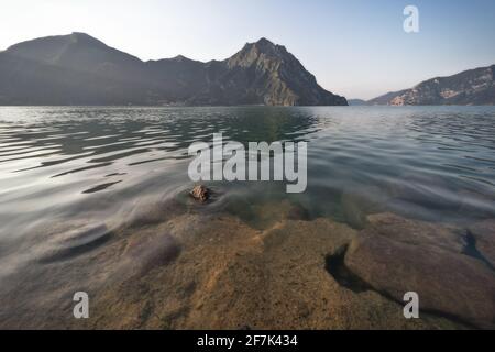 Scenic view of mountains and rocks over water Stock Photo