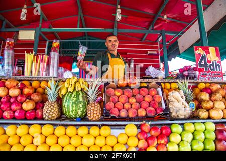 Friendly fresh juice seller. The famous Djema el Fna square. Marrakech, Morocco - September 23, 2019. Stock Photo