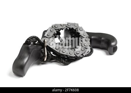 Black pocket hand chain saw isolated on white background. Tool for cutting wood and pruning branches. Saw for garden, hiking and firewood harvesting. Stock Photo