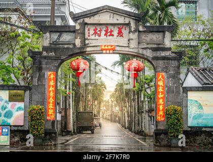 Haikou China , 22 March 2021 : Stone gate at the entrance of Meishe volcanic village made of volcanic rock in Haikou Hainan China Stock Photo