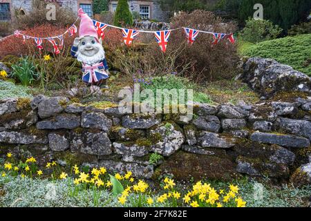 A jolly patriotic gnome in a cottage garden in the village of Monyash, near Bakewell, Peak District National Park, Derbyshire Stock Photo