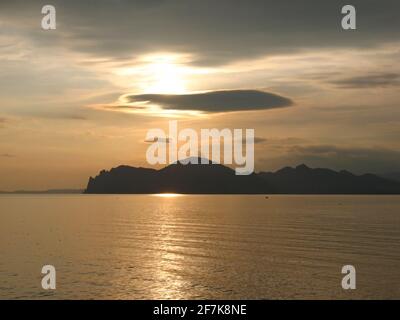 Beautiful golden sunset over the sea and mountains. High quality photo Stock Photo