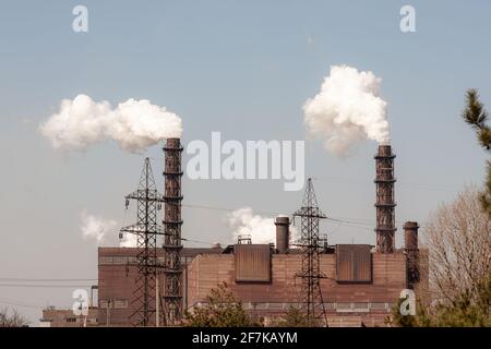 Environmental pollution. Smoke from the pipes of a mining plant.  Stock Photo